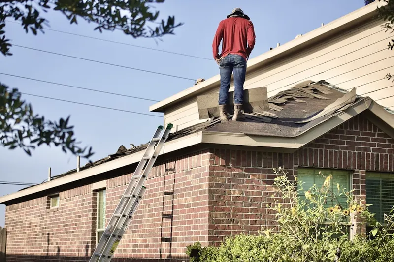 Professional roofer working on a residential roof in West Coon Rapids